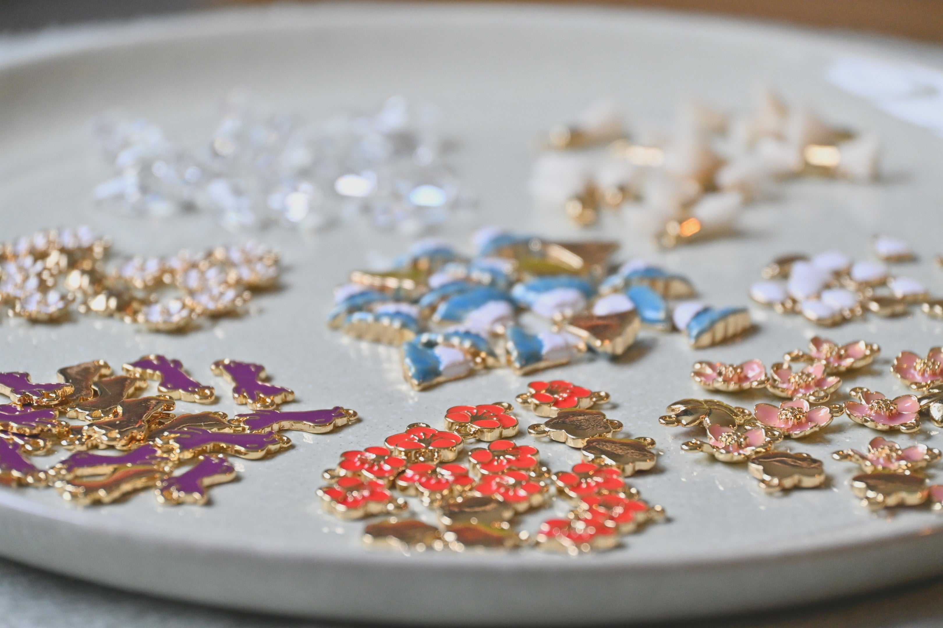 Colourful decorative Japanese themed charms on a white plate