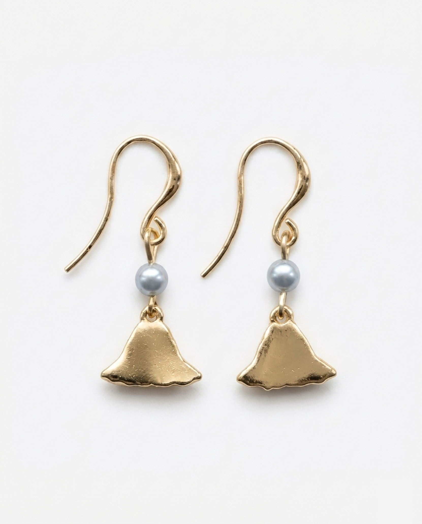Backside of a gold earring with charm of mt fuji and light blue pearl