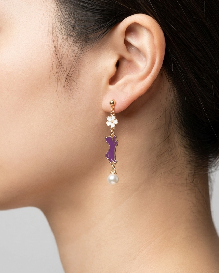 A close up of model wearing a pair of earring with white sakura and purple cat charms with white pearl 